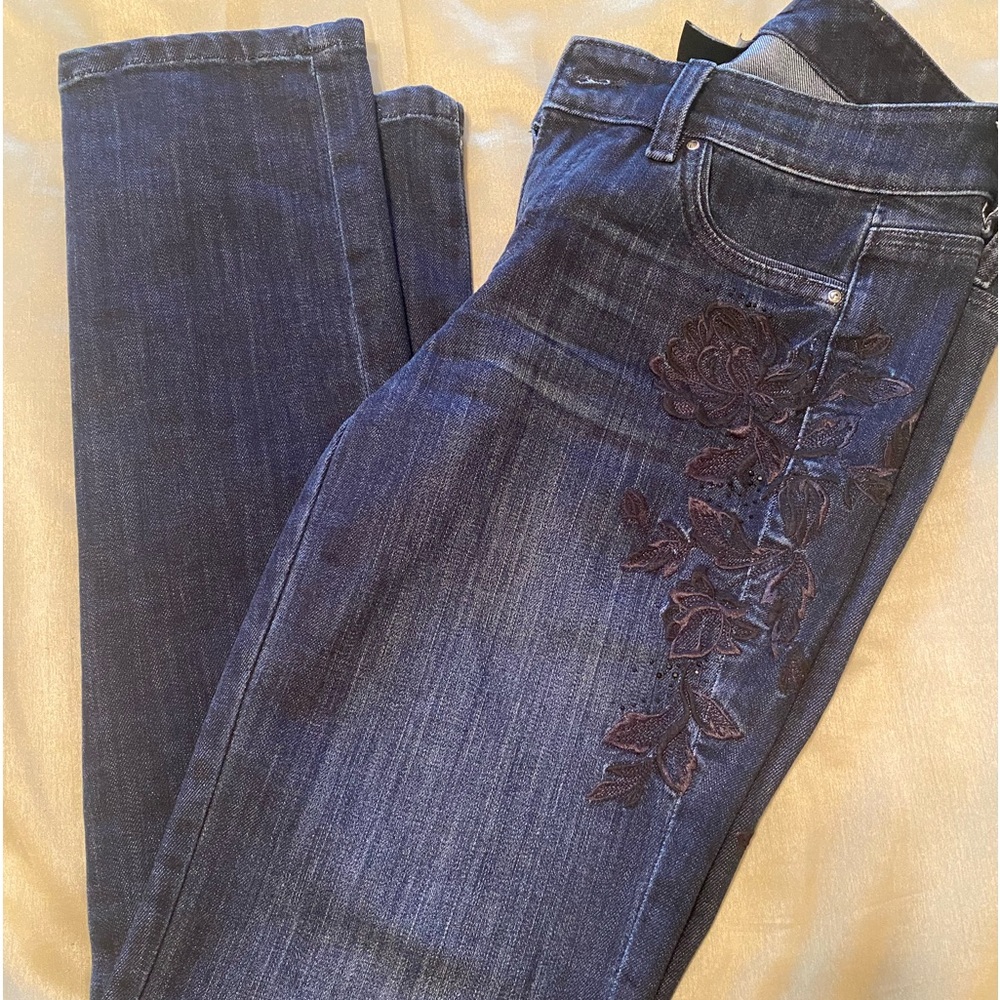 Dark wash jeans with black embroidery